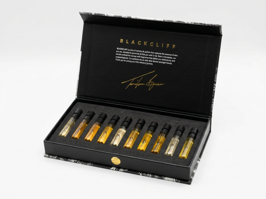 Black collector set box with row of 10 dropper vials, some gold, some clear